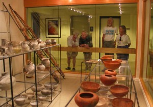 Visitors view pottery at the Edge of the Cedars Museum