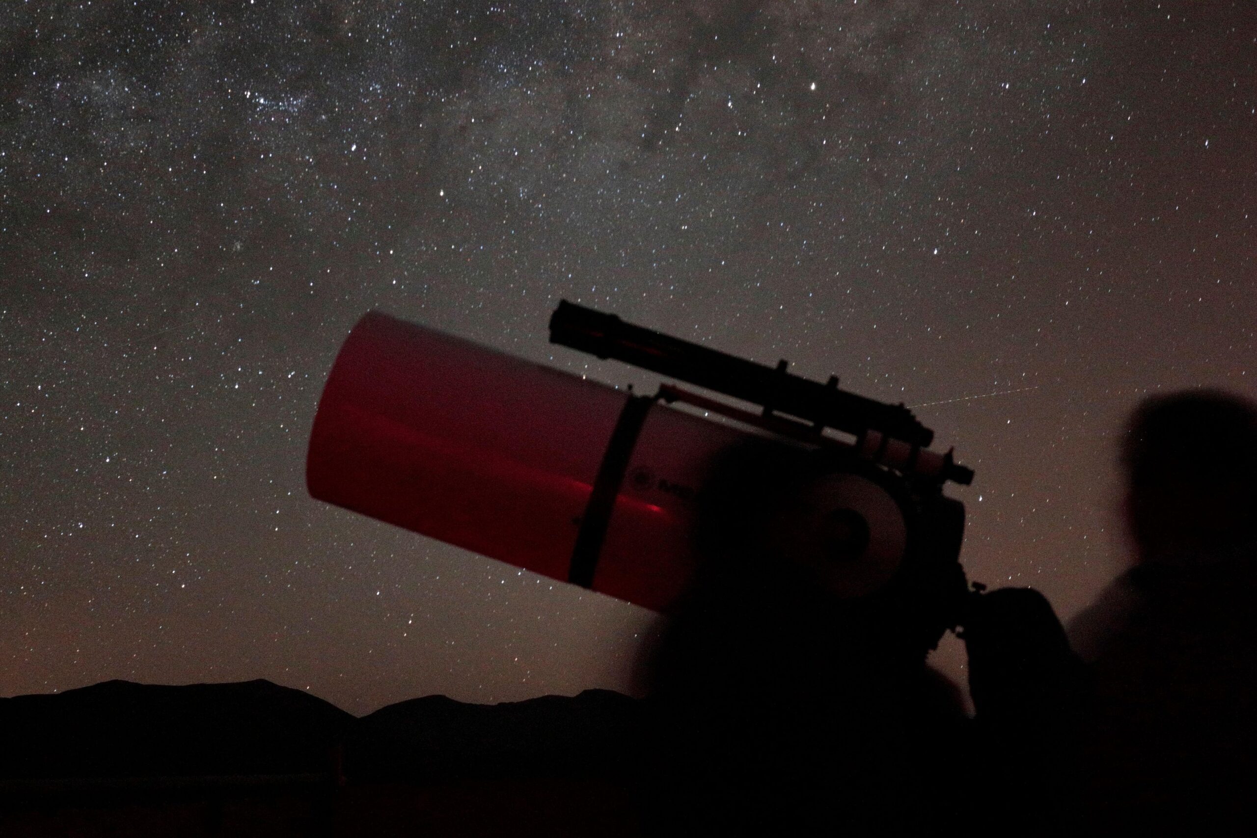 Telescope against starry sky